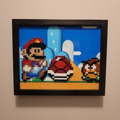 an image of mario and his friends on the nintendo wii game wall hanging in a black frame