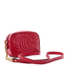 This is an authentic GUCCI Calfskin Matelasse Mini GG Marmont Chain Shoulder Bag in Hibiscus Red. This shoulder bag is crafted of smooth and supple calfskin leather in red with chevron detailing. This bag features an aged gold chain and leather shoulder strap and a Gucci GG logo on the front. The top zipper opens to a beige microfiber interior with a flat pocket. Hibiscus Red, Gg Logo, Gg Marmont, Chain Shoulder Bag, Hibiscus, Gold Chain, Gold Chains, Calf Skin, Shoulder Strap