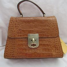 Description: Brand: Patricia Nash Chauny Condition: New With Tags Color: Cognac/Brown Material: Leather Style: Crossbody Hardware: Polish Dust Cover: Yes Closure: Zipper Bag Height: 8.0" Inches Bag Width: 10" Inches Bag Depth: 4.0" Inches Exterior Details: 1 Pocket Interior Details: Zipper Pockets And 2 Elastic Pockets, 1 Side Pockets Inside The Purse Saddle Bag Purse, Crossbody Saddle Bag, Tan Purse, Tooled Leather Purse, Italian Bags, Exterior Details, Brown Leather Shoulder Bag, Black Leather Crossbody Bag, Crossbody Clutch