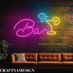 a neon sign that says bar next to a couch in front of a brick wall