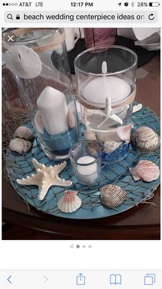 a blue tray with candles and seashells on it is shown in an instagram