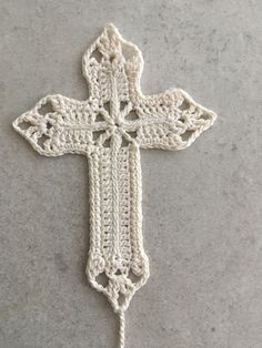 a crocheted cross is shown on the ground