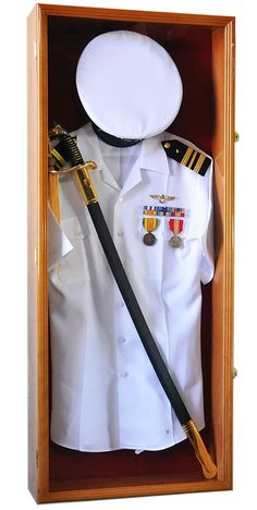 a white shirt and black tie in a wooden box with an officer's medal