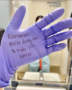 a purple glove with writing on it in front of a bathroom mirror that says, remember you're doing this to make life better