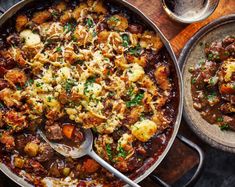 a large pot filled with food next to two glasses