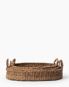 a large basket with rope handles on the bottom and two handles at the top, in front of a white background