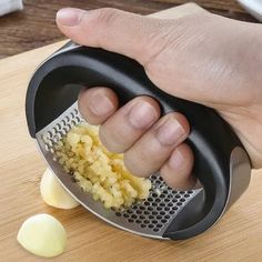 a person grating potatoes with a grater on a cutting board next to an onion slicer