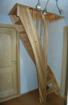 there is a wooden spiral staircase in the room