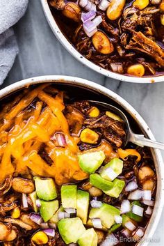 two bowls filled with chili beef and avocado