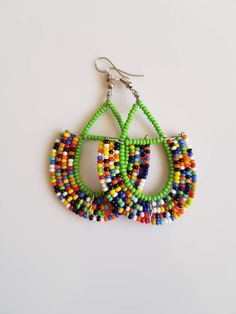 This listing is for ALL 9 pairs. The earrings are 100% handmade using original fine beads. Colorful and bright colors. ^^These earrings ships through dhl express. Buy multiple items and pay shipping for ONE item ONLY. Colorful Traditional Earrings, Traditional Handmade Multicolor Hoop Earrings, Handmade Traditional Multicolor Hoop Earrings, Handmade Multicolor Traditional Hoop Earrings, Traditional Handmade Green Hoop Earrings, Multicolor Hoop Earrings With Large Beads As Gift, Traditional Green Teardrop Beaded Earrings, Colorful Handmade Hoop Earrings, Traditional Multicolor Dangle Earrings