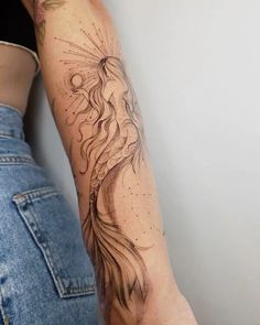 a woman's arm with an intricate tattoo design on the left side of her arm