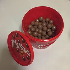 two red bowls filled with chocolate covered candies