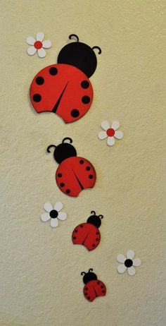 three ladybugs are hanging on the wall