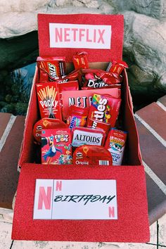 a red box filled with candy sitting on top of a table