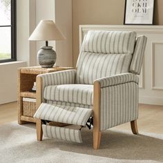 a striped recliner chair in a living room with a lamp on the side table