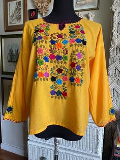 Absolutely beautiful hand made floral embroidery Mexican top Thin and lightweight cotton  The entire top is hand made, irregularities are expected  The flowers are colorful and beautifully made I presume it is an M size Approximate measurements are taken flat  Armpit to armpit 21" Length 23" Excellent vintage condition Embroidery Mexican, Mexican Top, Mexican Blouse, The Flowers, Beautiful Hand, Floral Embroidery, Womens Clothing Tops, Labour Day, Hand Made