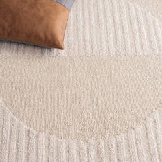 a close up view of a bed with a pillow and blanket on top of it