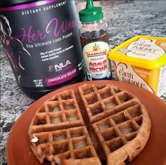 a plate with waffles on it next to some yogurt and other ingredients