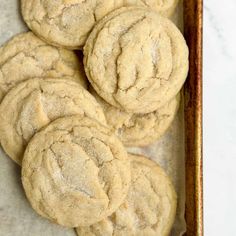 freshly baked cookies in a wooden tray on a marble counter top, ready to be eaten