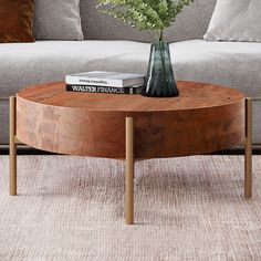 a living room with a couch, coffee table and flowers