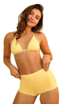 The Farrah Short brings style and comfort without skipping on fun. With its elastic waist, these shorts are the perfect fit for any adventure! 80% Nylon 20% Spandex Imported from Vietnam Booty short coverage Elastic waist Yellow Swimwear With Built-in Shorts For Vacation, Casual Elastane Beach Bottoms, Casual Elastane Bottoms For Beach, Yellow Stretch Shorts For Beach, Summer Beach Shorts With Elastane, Stretch Yellow Shorts For Beach Season, Summer Beach Shorts Made Of Elastane, Yellow Fitted Short Swimwear, Yellow Stretch Shorts For Vacation