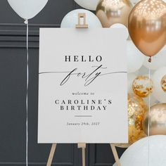 a welcome sign with balloons and streamers in the background for a birthday or bridal party