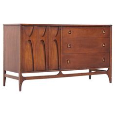 the sideboard is made from wood and has three drawers