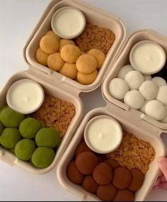 four plastic containers filled with different types of desserts and marshmallows in them