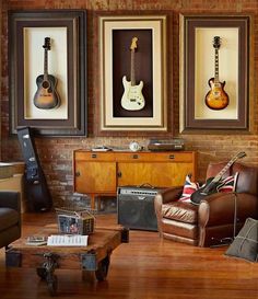 a living room filled with furniture and pictures on the wall next to a guitar case