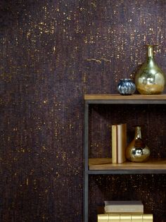 a shelf with books and vases on it in front of a wallpapered background