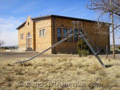 an old building with a metal slide in front of it