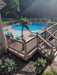 an above ground swimming pool with decking and railings