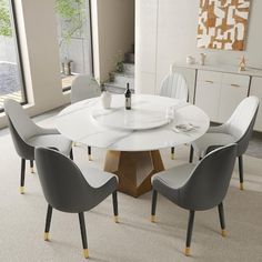 a white table with four chairs around it