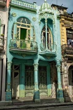 an old building with balconies painted blue