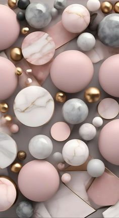 many different colored balls and shapes on a white surface with gold, silver, and pink accents