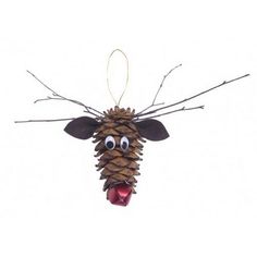 a pine cone ornament with a funny face on it's head and tongue sticking out