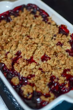 a close up of a tray of food with fruit on it and oatmeal crumbles