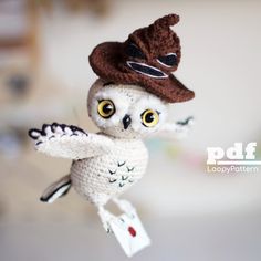 an owl with a hat on its head is flying