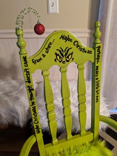 a green rocking chair with some writing on it