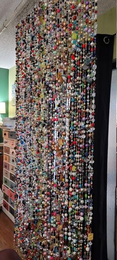 a room filled with lots of different types of buttons hanging on the wall next to a bed