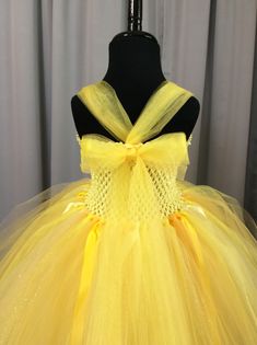 Fuzzy Duckling Design dresses ~ handcrafted for the little princess in your life. Our beautiful dresses feature a stretchy, crocheted bodice that is fully lined for both comfort and modesty. The full skirts sparkle and shine with three layers of high quality tulle in matte, shimmer, and glitter finishes. Satin ribbons, flowers, and jewels are added to make each dress something special. She'll feel like a fairy princess when wearing her matching accessories. This dress includes a matching sparkly Princess Style Fairy Dress For Pageant, Princess Style Fairy Dress For Pageants, Fairycore Tulle Tutu Dress For Parties, Yellow Tulle Princess Dress, Yellow Tulle Tutu Dress For Pageant, Princess Style Tulle Dress For Costume, Princess Style Tutu Dress In Tulle For Costume, Princess Style Tutu Dress For Costume, Fairy Style Tulle Tutu Dress For Costume Party