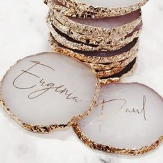 some white and gold cookies are stacked on top of each other with the words virginia paul written on them