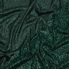 The Emerald City outdid itself on this beautiful Gala Dark Emerald and Black Double Faced Glitter Tulle. A black tulle base is adorned with black and dark green glitter on both sides, with one side showing a finer glitter than the other. The crisp hand and weighted drape make it an excellent choice for evening gowns, skirts, ball gowns, and bold capes, or use it for special occasion dresses, such as for weddings or quinceañeras. Opaque, a lining can be used for comfort if desired. Dark Green Glitter Dress, Emerald Green Aesthetic Tumblr, Metallic Shimmer Sequin Fabric For Evening, Black Glitter Sequin Fabric For Festive, Shiny Metallic Sequin Fabric For Evening, Metallic Shiny Sequin Fabric For Evening, Black Glitter Sequin Fabric For Festive Occasions, Metallic Sequin Fabric With Shimmer For Evening, Holiday Gala Sequin Fabric With Glitter