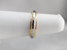 "Platinum and 18 karat yellow gold provide a beautiful weight upon the hand in this vintage wedding band. The minimalist style and milgrain edged creates a sophisticated style upon the hand! Metal: 18K Yellow Gold, Platinum Width of Band: 4.0 mm Height off Finger: 2.0 mm Ring Size: 4.25 Marks: \"18K & PLAT\" Stamped on the inside band SKU #: TMW38C4W Each piece has been identified and graded by a Graduate Gemologist who has been certified by the Gemological Institute of America (GIA). We hav Two Tone Wedding Band, Stacking Bands, Vintage Wedding Band, Gold Wedding Band, Gold Platinum, Metal Bands, Eternity Bands, Minimalist Style, Sophisticated Style