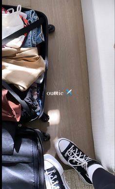 an open suitcase filled with clothes and shoes