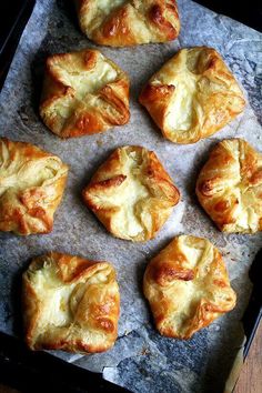 eight pastries are on a baking sheet ready to be baked in the oven,