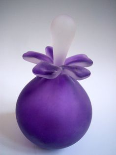 a purple vase sitting on top of a white table