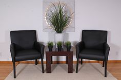 two black chairs sitting next to each other on a rug