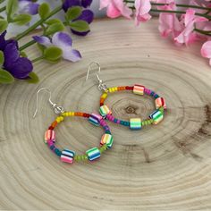 Hand Crafted Colorful Beaded Hoop Dangle Earrings Silver Earrings Swirl Detail Make A Style Statement With Our Exquisite Handcrafted Beaded Hoop Earrings! Bursting With Vibrant Hues, These Hoops Are Skillfully Made Using The Finest Polymer Clay And Glass Beads. With A Length Of 2.5 Inches, Including The Sterling Silver Ear Hook, They Offer A Perfect Blend Of Comfort And Elegance. Rest Easy Knowing That The Tiny 925 Stamp On The Hooks Signifies Their Authentic Sterling Silver Nature. Choose These Multicolor Wire Wrapped Dangle Beaded Earrings, Colorful Dangle Hoop Earrings With Ear Wire, Multicolor Wire Wrapped Beaded Earrings, Colorful Dangle Hoop Earrings, Multicolor Wire Wrapped Earrings With Round Beads, Rainbow Drop Earrings For The Beach, Rainbow Drop Earrings For Beach, Multicolor Wire-wrapped Beaded Earrings For Gift, Multicolor Wire Wrapped Hoop Earrings For Gifts