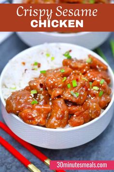 two bowls filled with chicken and rice next to chopsticks on the side,